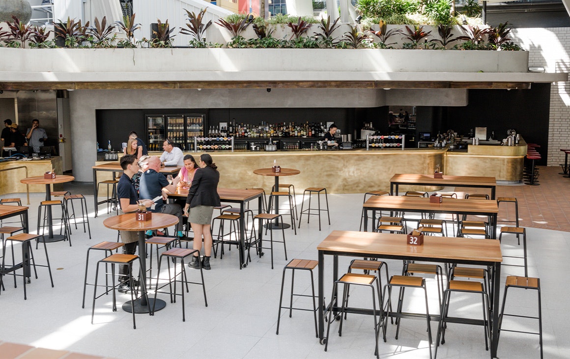 high tables in front of a brass bar